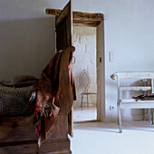 Rustic bedroom with wooden bed and open door