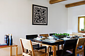 Dining room, wooden beamed ceiling and artwork on the wall