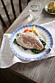 Poached fish fillet on a bed of chard
