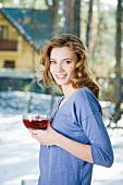 A young woman with a cup of fruit tea