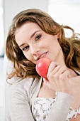 A young woman eating an apple