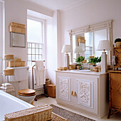 Country-style bathroom with woven baskets and antique mirror frame