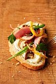 Slice of sandwich bread with roast duck, mushrooms and sliced peppers