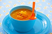 Pumpkin soup in a blue bowl