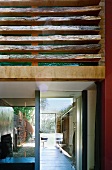 View through glazed living room into garden