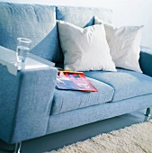 Cushions and a glass of water on a sofa