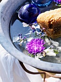 Washbasin with flowers and sponge in garden