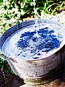 Water pouring into zinc tub in garden
