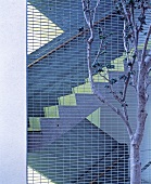 View of exterior staircase through metal grid