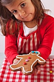 Little girl showing a gingerbread man