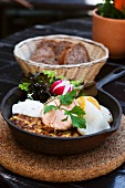 Potato pancakes and varieties of fish in a frying pan