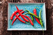 Red and green chilli peppers on a plate
