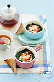 Spinach casserole with fried egg and tomato, toast and tea