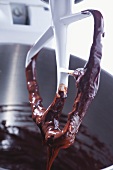 Chocolate cake mixture on a whisk