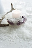 Candle holder made of ice with frozen berries