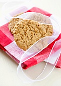 Oat biscuits tied with a ribbon on a kitchen towel