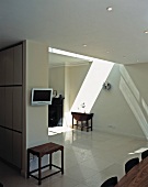 Open-plan living space with skylight