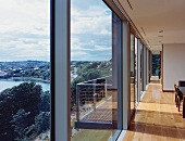 Living room with glass wall and view of river