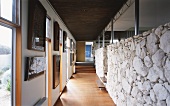 Corridor with one limestone wall and one wall decorated with pictures