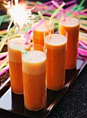 Carrot juice party drinks with straws