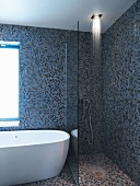 Shower area and bathtub in bathroom with mosaic tiles