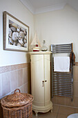 Bathroom with cream-colored storage and beach decorations