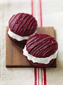 Two Red Velvet Whoopie Pies on a Board