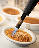 Crème brûlée being caramelised
