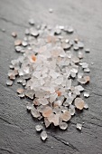 Himalayan salt sprinkled on a slate surface