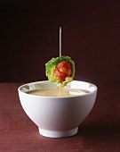 Cream of lobster soup with lobster skewer