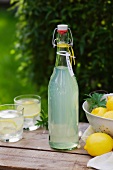 Home-made lemonade in a swing-top bottle and two glasses