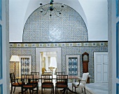 Traditional, North African wall tiles in dining room with antique European furniture