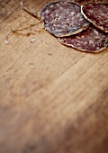Sliced salami on a wooden board