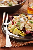 Potato and herring salad on a bed of chicory and radicchio