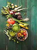 Various vegetables on a green wooden surface