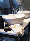 Two round washbasins on marble washstand