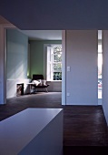 Anteroom with wide doorway and view into minimalist living space