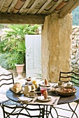 Breakfast table on roofed terrace