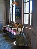 Room with vintage furniture, parquet flooring and windows with shutters