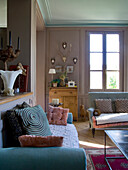 Living room with classic furniture, antler decorations and oriental carpet