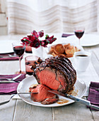 Roasted rib-eye steak on a laid table (England)