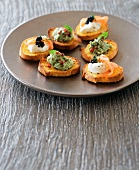 Crostini with guacamole and with cream cheese and salmon