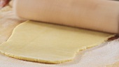 Rolling out shortbread dough with a rolling pin