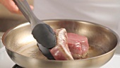 Searing fillet steaks in a frying pan
