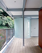 Cylindrical, glass installation on terrace of contemporary building