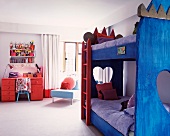 Bunk beds with blue-painted wooden frame in children's bedroom