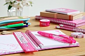 Pink writing materials on child's desk