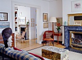 Living room with open fireplace and doorway to room beyond