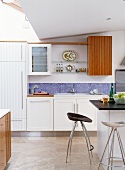 White kitchen with island & bar stools