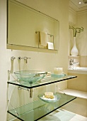 Modern, cream bathroom in classic setting with glass washstand and basin